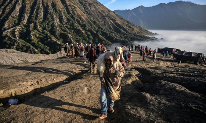 Fiéis sobem vulcão ativo na Indonésia para jogar animais como oferenda